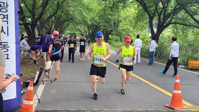 ‘2022 대청호 벚꽃길 마라톤 대회’에 참가한 마라토너들이 결승선을 통과하고 있다. 조선교 기자