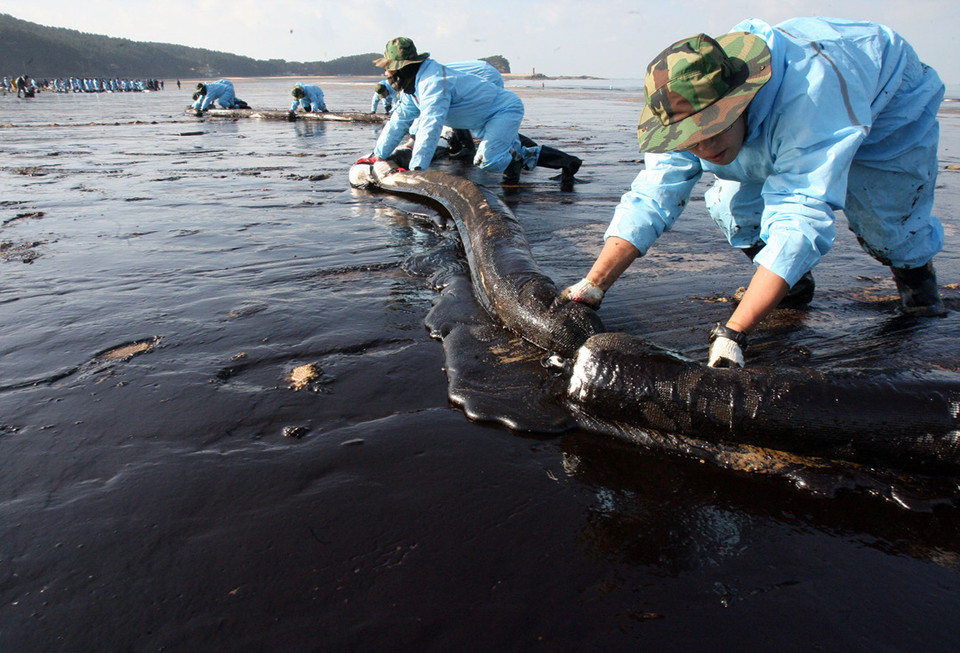 태안 기름유출 피해를 받은 만리포 해수욕장에서 민관군이 방제작업을 하는 모습. 2007년 12월 7일 충남 태안군 앞바다에서 홍콩 선적의 유조선 ‘허베이 스피릿 호’와 삼성물산 소속의 ‘삼성 1호’가 충돌하면서 유조선 탱크에 있던 총 1만2547킬로리터(7만8918 배럴)의 원유가 태안 인근 해역으로 유출됐다.