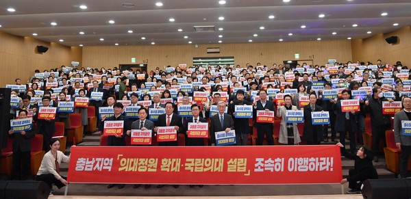 15일 충남도서관 대강당에서 열린 '충남 의대 정원 확대 및 국립의대 설립 범도민추진위원회' 출범식에서 참석자들이 손팻말을 들고 기념사진을 촬영하고 있다. 사진=연합뉴스 제공