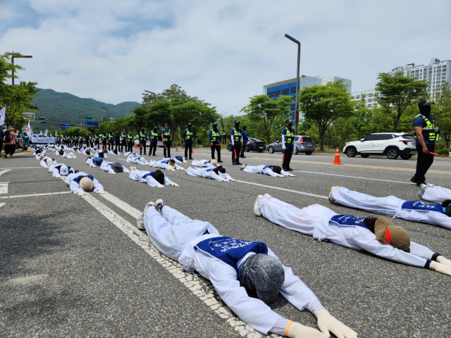 14일 충남장애인부모회 관계자들이 충남도청 앞에서 오체투지를 하고 있다. 사진=김지현 기자
