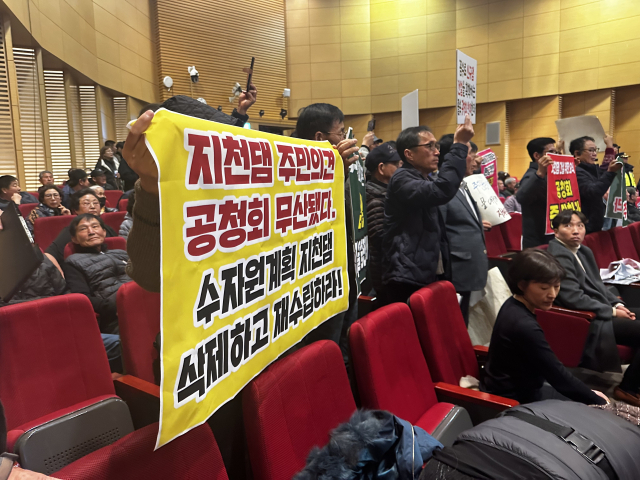 22일 환경부 주최로 열린 금강권역 하천유역수자원관리계획 공청회에서 지천댐 건설을 반대하는 주민들이 피켓을 들고 서있다. 사진=서유빈 기자