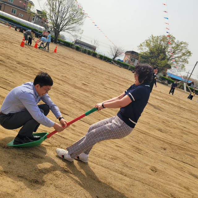 ▲전난 교장이 박양훈 교육장을 삽설매에 태워 전속력 질주하는 릴레이 현장, 웃음 폭발! “교육장님, 꽉 잡으세요~!” 사진=김흥준 기자