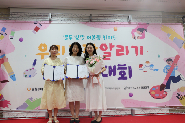 12일 ‘2025 열두빛깔 어울림 한마당 우리고장 알리기 그리기 대회’ 시상식에서 손희순(가운데) 충북도교육청 교육국장이 지도교사상을 수상한 이영희(왼쪽, 금천초)·김은서(백곡초) 교사와 기념사진을 찍고 있다. 사진=이용민 기자