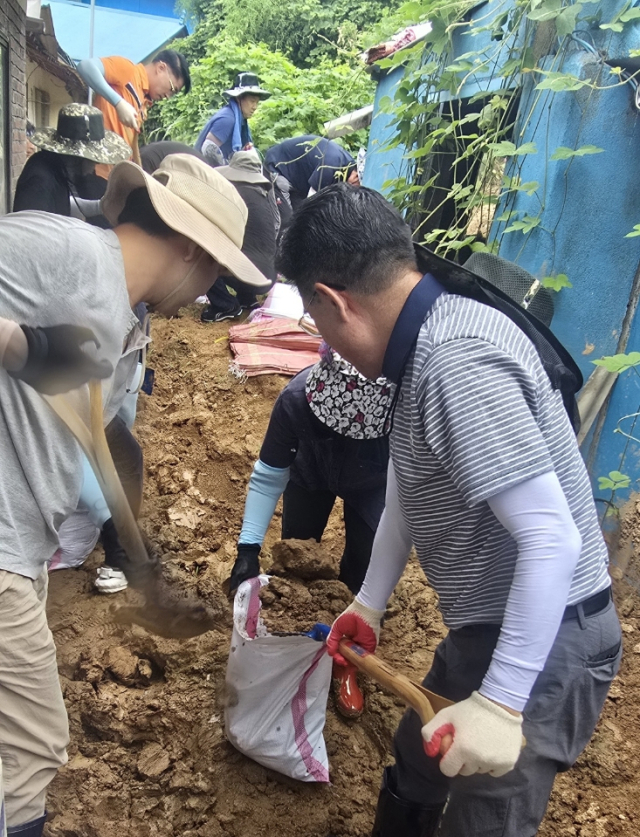 ▲수해복구에 구슬땀을 흘리고 있는 이응우 시장을 비롯해 직원들.
