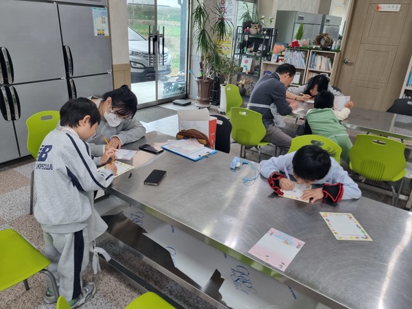 ▲ 가족사랑 엽서함 활동에 참여한 시민들이 정성스럽게 손편지를 작성하며 가족에게 마음을 전하고 있다. 사진=유지석 명예기자