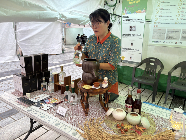 신창노씨 집안 문중술 ‘노산춘’ 전승자 이미리 관장은 지나가는 시민에게 술을 소개하고 있다. 사진=김세영 기자